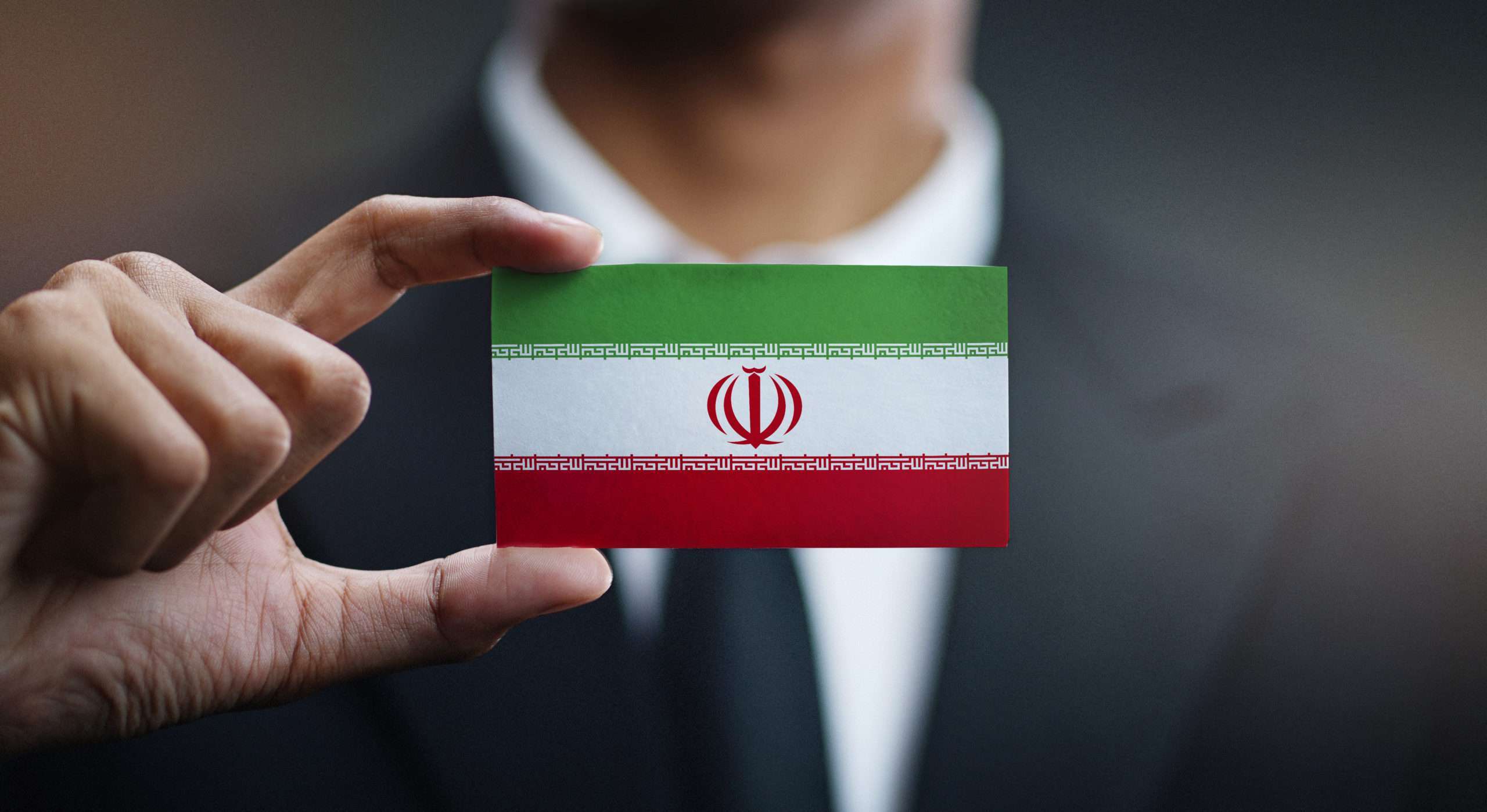 Businessman Holding Card of Iran Flag